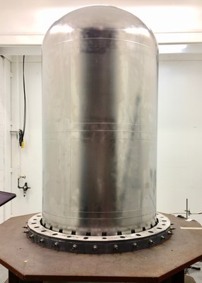 The new fuel tank for Lockheed Martin's largest satellites host 3-D printed domes that cap off the cylinder. Using this manufacturing method, tank delivery time went down from two years to three months. Here the tank is seen in a test fixture, with a 3-D printed dome seamlessly integrated into the body of the tank.