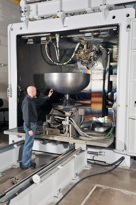 A Lockheed Martin engineer inspects one of the 3-D printed dome prototypes at the company's space facility in Denver. The final dome measures 46 inches in diameter, large enough to fit 74.4 gallons of liquid.
