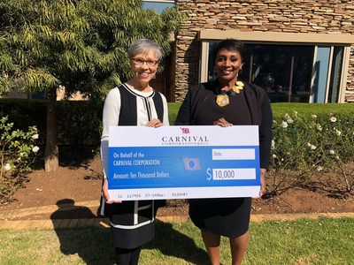 Carnival Corporation's chief procurement officer, Julia Brown (right), presented a check for $10,000 to the Oprah Winfrey Leadership Academy Foundation in support of university scholarships for graduates of the the Oprah Winfrey Leadership Academy for Girls - South Africa, during a visit today to the school in Johannesburg, South Africa. Pictured at left is Rebecca Sykes, President of the Oprah Winfrey Charitable Foundation.
