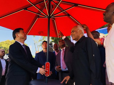 Minister Song Tao and Dr. Salim. Salim lit up the solar umbrella from Hanergy