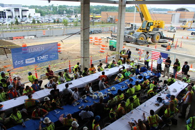 Enjoying lunch and celebrating the major construction milestone of topping out at LMC's Lumen at Tysons, a mixed-use luxury apartment community. Hoar Construction and its trade partners celebrated by raising the final beam of the structure.