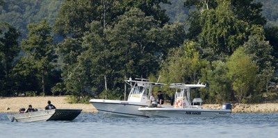 Emergency workers patrol an area Friday, July 20, 2018, near where a duck boat capsized the night before resulting in at least 13 deaths on Table Rock Lake in Branson, Mo. (AP Photo/Charlie Riedel)  - note: photo credit must be included