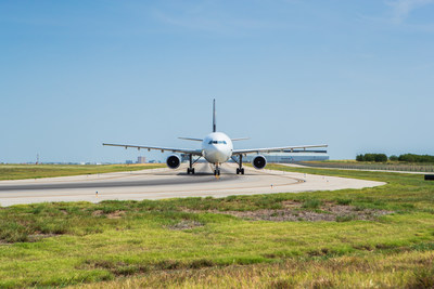 An aircraft uses the end-around taxiway that DFW Airport opened in 2008.  DFW Airport today received a funding commitment from the Department of Transportation for $180 million to build two more end-around taxiways.