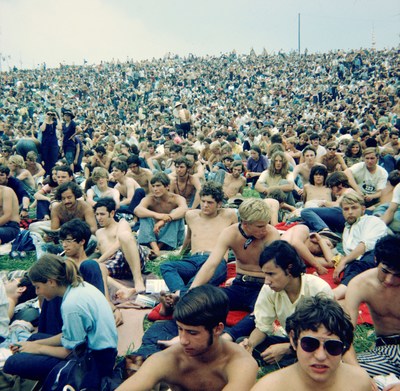 A view from the Woodstock audience looking up the hill toward the Food for Love stands on Friday afternoon, before the rain began. Photo by Richard Gordon. Bethel Woods Collection, gift of Richard Gordon.