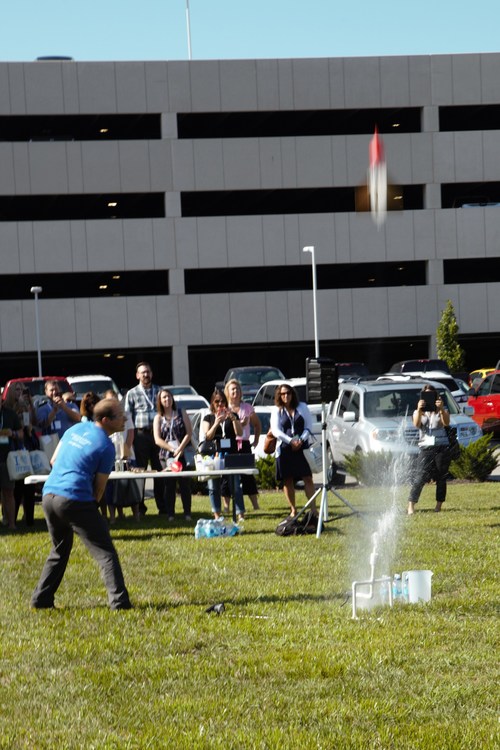Burns & McDonnell employee-owners demonstrated engaging STEM activities to educators they could recreate for their students at school, such as launching a water bottle rocket to learn about Newton's Law of Motion.