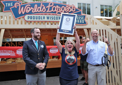 Chad Vincent, Dairy Farmers of Wisconsin CEO did the honors cutting the ribbon as the GUINNESS WORLD RECORDS adjudicator made “The World's Largest Cheeseboard” official and Suzanne Fanning, Dairy Farmers of Wisconsin VP of Marketing Communications proudly showed off the winning certificate; Photo Credit: Dairy Farmers of Wisconsin