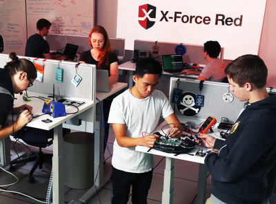 Members of IBM X-Force Red, a team of seasoned hackers, testing for security issues in consumer electronics at a new secure testing facility in Austin, TX, Monday, August 6, 2018. In the Lab, the team will search for vulnerabilities in consumer and industrial IoT technologies, automotive equipment, ATMs and other systems before and after they are put into market. The Austin facility is one of four X-Force Red Labs, announced today by IBM Security. (Jack Plunkett/Feature Photo Service for IBM) (PRNewsfoto/IBM Security)