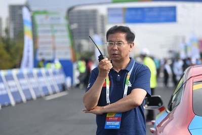 Gaizang Cairang, the head of the Sport Department of Qinghai Provincial government, is supervising the organization of the Tour of Qinghai Lake (Xinhuanet Photo)