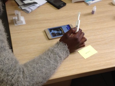 A patient using the mobile app to guide her through HIV self-testing instructions