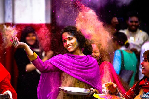 Woman throwing rainbow-dyed powder in celebration of Holi, the annual colourful festival of love. Travellers can witness this magical event by booking with WOW air -- flights starting at $299 from January to March. (CNW Group/WOW air)