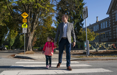 Shawn Pettipas, Director of Community Engagement at BCAA with his daughter as they cross the street in a soon to be busy school zone (CNW Group/British Columbia Automobile Association (BCAA))