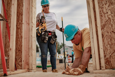 Country superstars Trisha Yearwood and Garth Brooks prepare a doorway on a new Habitat for Humanity Home in Mishawaka, Indiana. Additional photos of the 35th Jimmy & Rosalynn Carter Work Project are available at www.habitat.ngo/CWPphotos. Photos may be credited to Habitat for Humanity International.