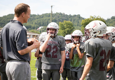 Riddell brand ambassador Peyton Manning (left) surprised Rogersville Middle School of Rogersville, Tennessee with new football equipment as part of Riddell's 2018 Smarter Football program on August 24.