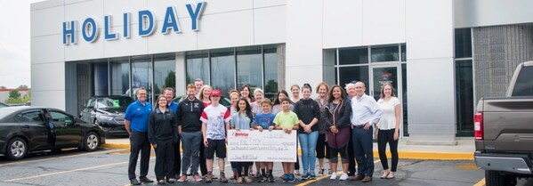 Faculty, staff, students and parents accepted the check from Ford at Holiday Ford in late August.