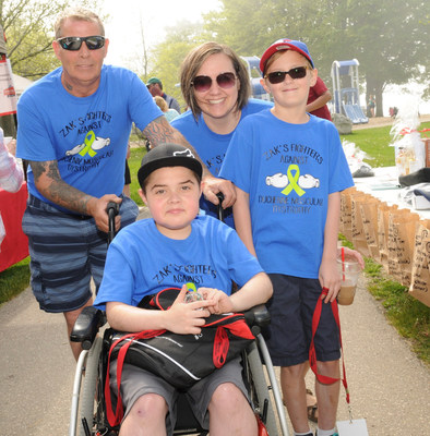 Zachary Mitchell, who lives with Duchenne muscular dystrophy (DMD), is surrounded by his mom Valerie, his dad Rick and his twin brother Nicholas. The Mitchells, who reside in Bowmanville, Ontario, are thankful for Muscular Dystrophy Canada’s Personal Empowerment Program, which helps families affected by DMD.  The program, which is available across Canada, is a 2018 recipient of a global STRIVE award, created by PTC Therapeutics Inc. (CNW Group/Muscular Dystrophy Canada)