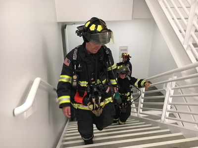 Lt. Emmett Larkin of Sunnyvale DPS leads a team up the stairs at Moffett Towers II Building 1 during a high-rise firefighting exercise.