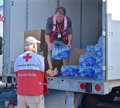 Mary Bos, a Red Cross logistics volunteer, unloads a pallet of water in Charleston, S.C. Her husband is a logistics lead volunteer for the Red Cross and taught her how to use a forklift.  Red Cross photo by Bob Wallace