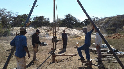 A photograph of the drilling team and site