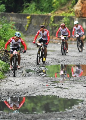 The team from the Zunyi Medical University are racing in the mountain bike cycling competition on September 18. (PRNewsfoto/Wulong Publicity Dept.)