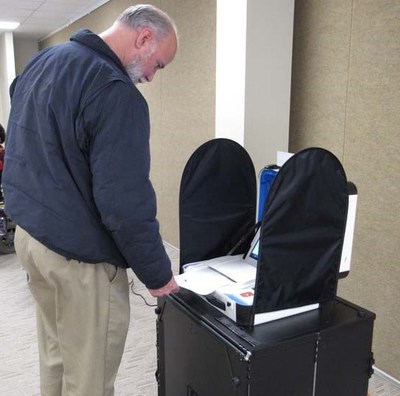 The mock election put every aspect of Verity to the test. Here a voter scans his completed ballot.