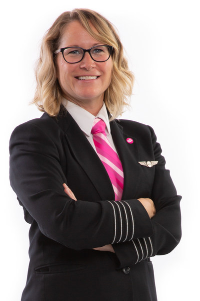 Carey Steacy, WestJet Captain and Breast Cancer Awareness Month Ambassador wearing custom-designed pink neckwear and pink 'personality' pin (CNW Group/WESTJET, an Alberta Partnership)