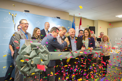 Sundial CEO, Torsten Kuenzlen surrounded by his board, executives and elected officials cutting the ribbon to mark the opening of the company's flagship facility in Olds, Alberta. (CNW Group/Sundial Growers)