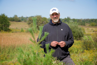 Green Leader, Andrew MacMillan, with a White Pine Tree on Country Day School Grounds. (CNW Group/Forests Ontario)