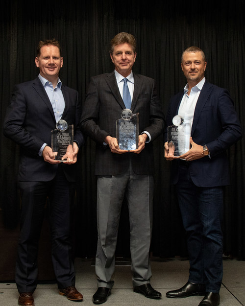 Scientific Games Executive Vice President of Sports Keith O'Loughlin, Group Chief Executive of Lottery Jim Kennedy and Group Chief Executive of Digital Matt Davey proudly display three Global Gaming Awards the Company received at the Global Gaming Expo in Las Vegas.
