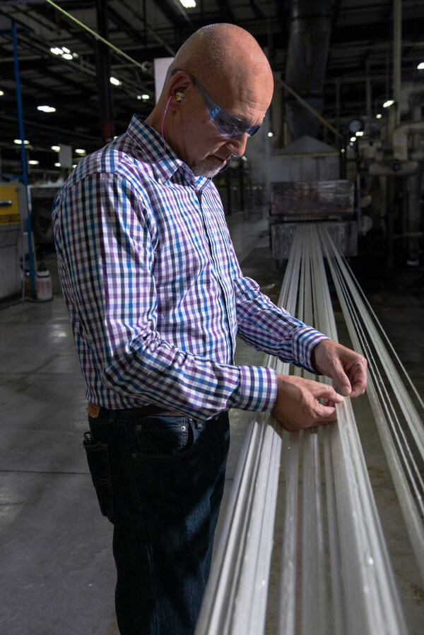 PrimaLoft product development engineer interacting with PrimaLoft® Bio during initial fiber run at production facility.