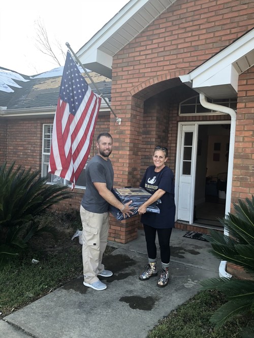 Brian Hood, Army EOD National Guard and Kellie Perry, EODWF Board member work together to deliver tarps and other supplies to EOD families during Hurricane Michael relief efforts.