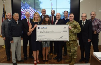 PenFed Credit Union Board of Directors presents Lisa Hallett, Executive Director/Co-Founder of wear blue: run to remember with a $10,000 donation check during its October 30 board meeting.