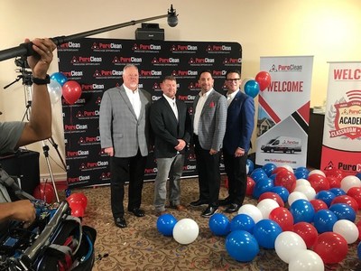 Pictured from left to right: Steve White, PuroClean president and chief operating officer; Grant Springer, free franchise winner; Tim Courtney, vice president of franchise development and creator of PuroVet; Mark Davis, PuroClean co-chairman and chief executive officer