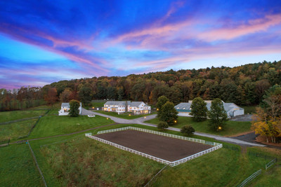 Equestrian amenities include a large barn with 22 stalls and an indoor riding arena, a carriage house with 10 additional stalls and guest/staff quarters, an outdoor riding arena, multiple paddocks and more. NewYorkLuxuryAuction.com.