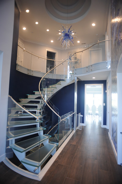 Custom floating grand glass & metal statement staircase.
