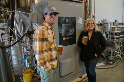 Josh Hare, founder & president, Hops & Grain Brewing in Austin, Texas and Earthly Labs founder & CEO Amy George, stand in front of CiCitm, a plug-and-play carbon capture technology for craft brewers.