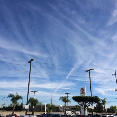 Geoengineered sky above San Diego, California. The jet-sprayed particulate pollution trails spread out eventually becoming a white haze.