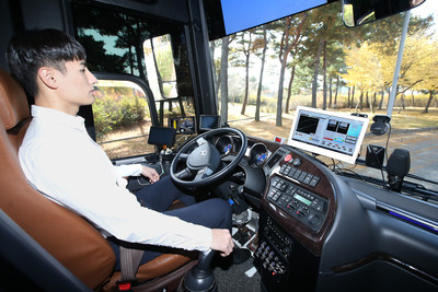A KT employee is photographed while checking signals delivered to the company’s self-driving bus during its test run at Incheon International Airport on November 11.