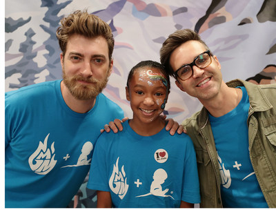 Good Mythical Morning co-hosts Rhett and Link smile alongside a patient at St. Jude Children's Research Hospital.