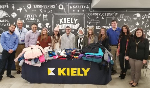 Team Members of the Kiely Family of Companies Corporate Headquarters in Tinton Falls, New Jersey presenting their donation of winter wear for the United Way Warmest Wishes Drive.
