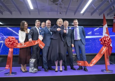 Accenture's North American President & CEO, Julie Sweet cuts the ribbon to open the company's Canada Innovation Hub in Toronto, with (L-R): Managing Director Iliana Oris Valiente, Toronto Mayor John Tory, incoming Canada President Jeffrey Russell, Ontario Minister of Economic Development, Job Creation and Trade Todd Smith, Accenture's Canada President Bill Morris, and CMHC CEO Evan Siddall on Tuesday, November 27, 2018.  THE CANADIAN PRESS IMAGES/J.P. Moczulski (CNW Group/Accenture)