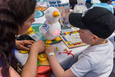 Maxwell, a 4-year-old cancer patient, creates a personalized necklace for his new friend, My Special Aflac Duck, following a fun scavenger hunt at Children’s Hospital in New Orleans on Thursday, Nov. 29, 2018. Aflac, a long-time supporter of children and families facing childhood cancer, hosted a special delivery event for several children at the hospital to debut the company’s new robotic, caring companion for children coping with cancer.