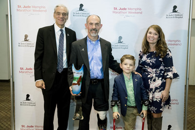 (From left to right) Richard Shadyac Jr., President and CEO of ALSAC, the fundraising and awareness organization for St. Jude Children's Research Hospital, St. Jude Hero Kent Stoneking, patient Kael and his mom Ashley gather after recognizing Stoneking as the Hero Among Us Award winner.
