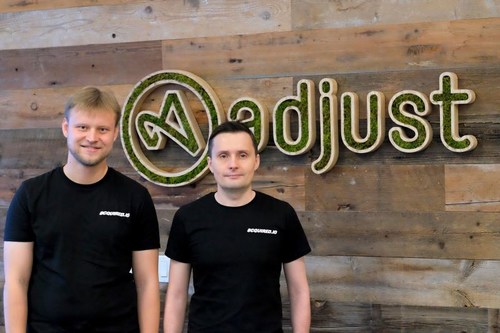 Acquired.io Founders with Adjust logo. Andrey Kazakov (left), Max Gannutin (right) (PRNewsfoto/Adjust GmbH)