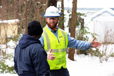 Duke Energy employee Dustin Richardson talks to a customer during power restoration efforts in Warren County, N.C.