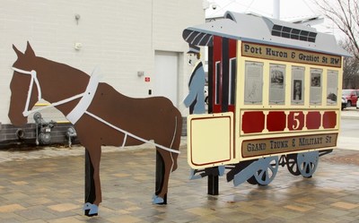 SCULPTURE CAPTURES TRANSIT HISTORY: Blue Water Area Transit’s unveiled sculpture tells the story of transit innovation in Port Huron, Michigan, starting some 150 years ago with William Pitt Edison’s horse-pulled trolley service. (photo by Rose Norton).