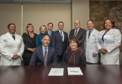 MACON, G.A. (Dec. 19, 2018) -- Eugene A. Woods, president and CEO of Atrium Health, and Ninfa M. Saunders, president and CEO of Navicent Health, are joined by board members and staff from both organizations, to celebrate the signing of the definitive agreement for the organizations’ strategic combination. As a result of this strategic combination, Navicent Health will be a hub for Atrium Health for central and south Georgia.