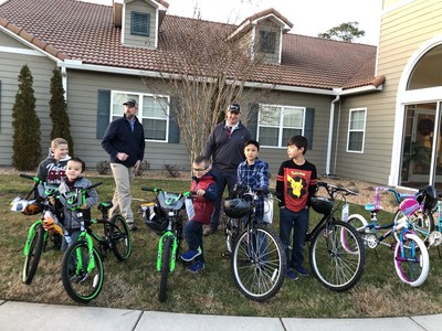 Essay winners from Langley Family Housing receive their new bicycles. Essay winners from Langley Family Housing receive their new bicycles.