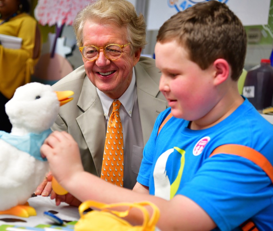 Aflac Chairman and CEO Dan Amos with a 13 year old patient at the Aflac Cancer and Blood Disorders Center in Atlanta, GA admiring the My Special Aflac Duck at a "duck delivery" event in September.