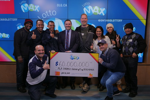 OLG's Senior Vice President of Enterprise Strategy and Analytics, Dave Pridmore (centre), celebrates a $60 million win with a group of nine from southern Ontario. The group won the December 21, 2018 LOTTO MAX jackpot. (CNW Group/OLG Winners)