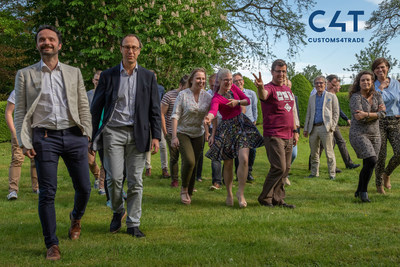 Team picture after a formal photoshoot in the garden of Customs4trade's new office in Zemst, featuring their CEO and COO. Picture shows the dynamic of the team very well.